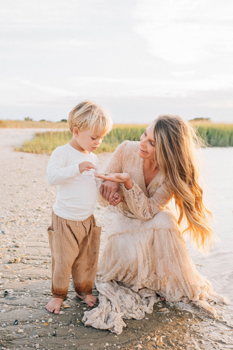 mama and son picking out shells on the beach at sunset photographed by Chelsea Hollis in Wilmington, NC