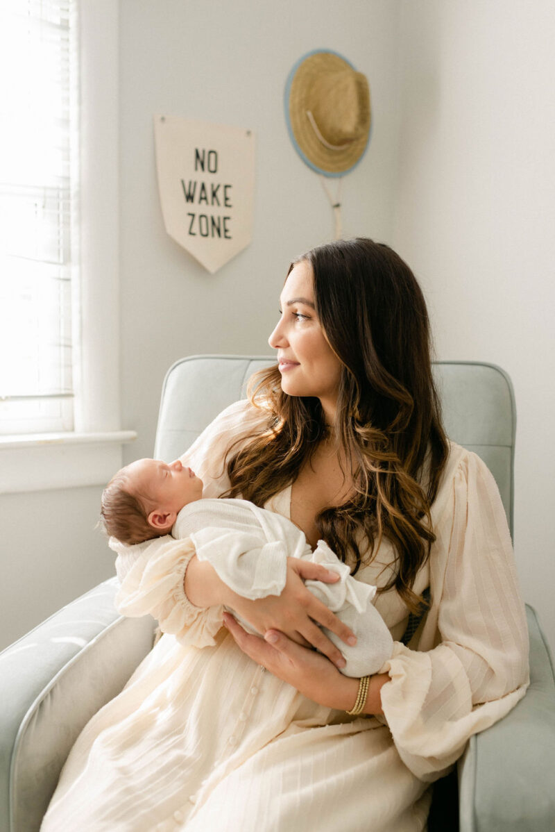 mama rocking newborn baby in nursery photographed by Chelsea Hollis in Wilmington, NC