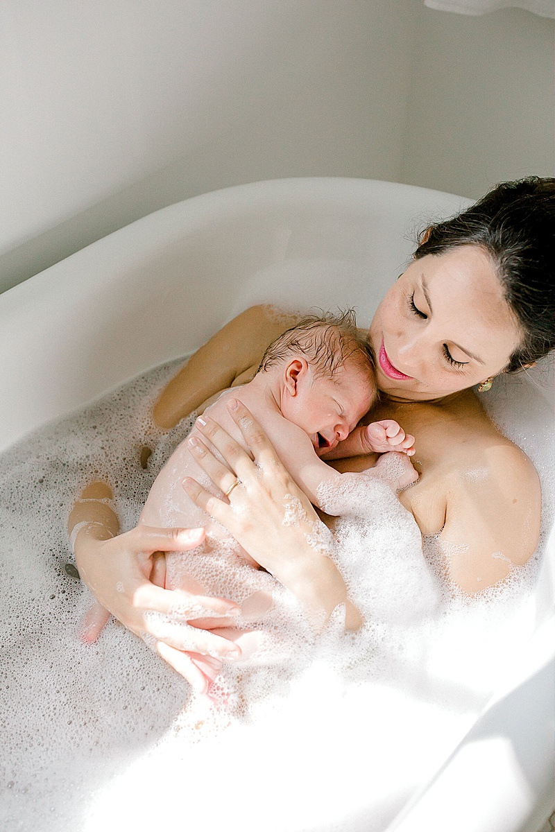 intimate newborn photography session in Richmond Virginia mama and baby in the bathtub featured by the motherhood anthology