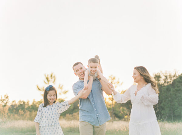family photography session in outdoor field photographed by Rooted Love Photography in Orlando, FL featured on The Motherhood Anthology blog