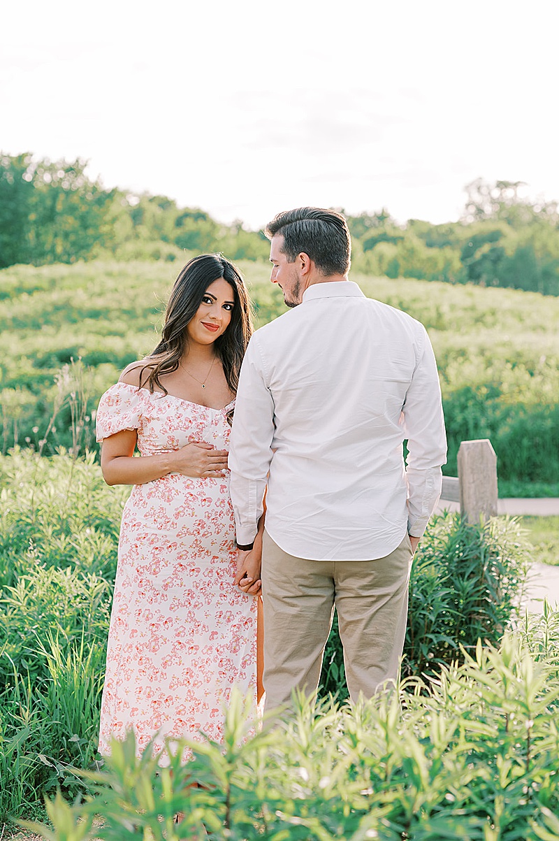 outdoor spring maternity session in Minneapolis, MN photographed by Claire Chantel Photography featured on The Motherhood Anthology blog, beautiful pregnant mama floral dress