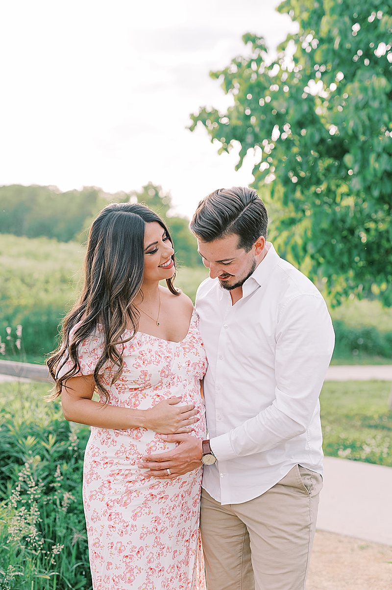 outdoor spring maternity session in Minneapolis, MN photographed by Claire Chantel Photography featured on The Motherhood Anthology blog, beautiful pregnant mama floral dress