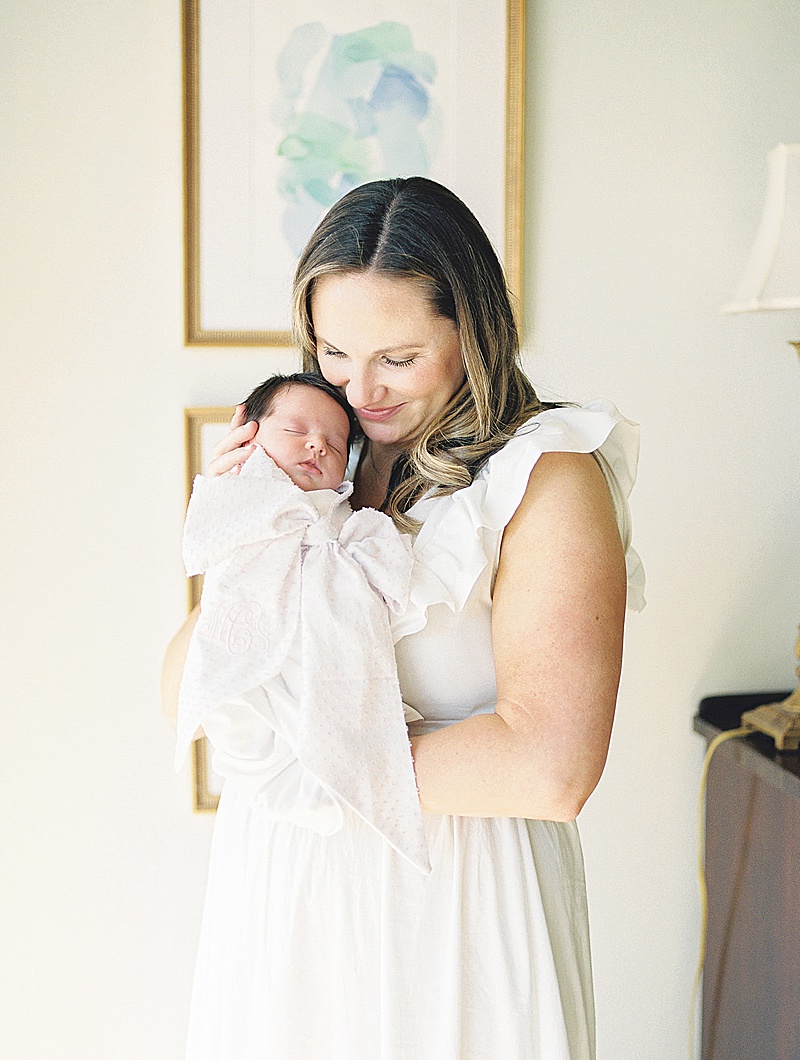 in-home newborn session natural light film photography Jessica brown photography featured on motherhood anthology blog mom and baby snuggling in nursery