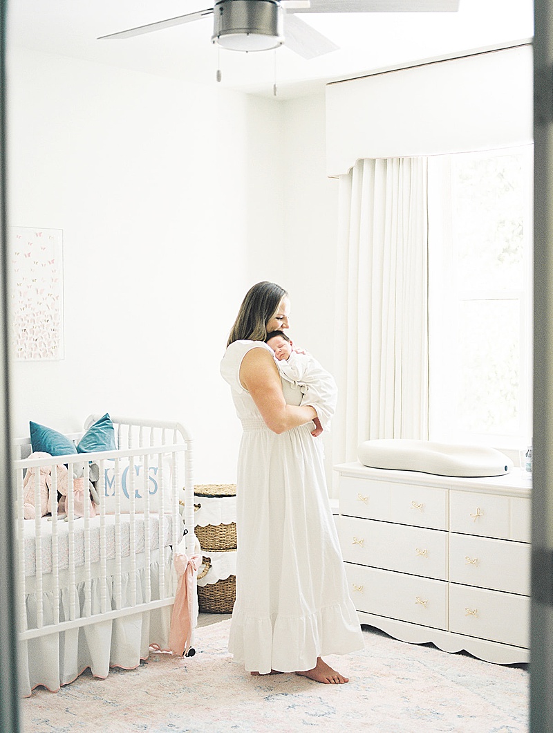 in-home newborn session natural light film photography Jessica brown photography featured on motherhood anthology blog mom and baby snuggling in girl nursery