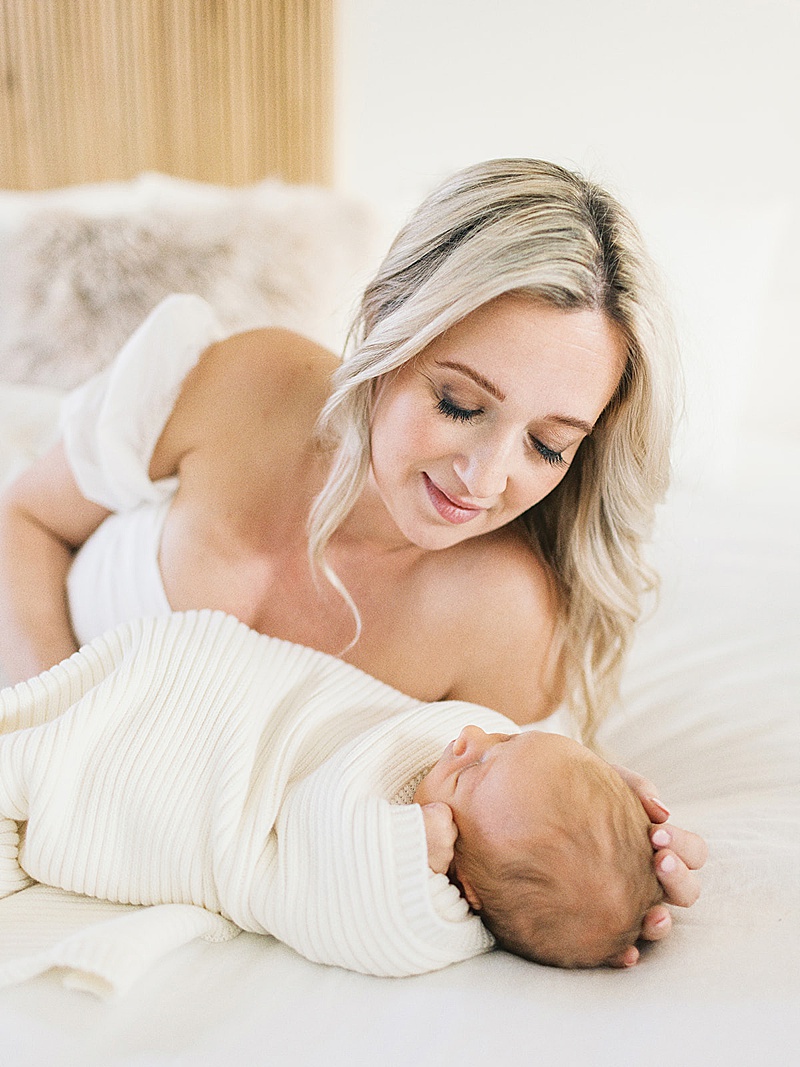 mom + newborn baby in home lifestyle session all white neutral photographed by Morgan Williams Photo in Raleigh, NC featured on The Motherhood Anthology blog